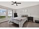 Bright bedroom with large windows, a ceiling fan, and dark wood-look tile flooring at 13111 Fruitville Way, Riverview, FL 33579