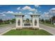 Elegant gated entrance to Triple Creek features decorative towers and lush landscaping at 13111 Fruitville Way, Riverview, FL 33579