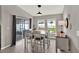 Open dining room with table, seating for six, and sliding doors to the backyard at 13111 Fruitville Way, Riverview, FL 33579