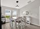 Dining area boasting a large wooden table, seating for six, and natural light from windows at 13111 Fruitville Way, Riverview, FL 33579