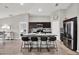 Modern kitchen featuring a large island with bar seating, stainless fridge and open floor plan at 13111 Fruitville Way, Riverview, FL 33579