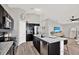 Kitchen with stainless steel appliances and island with seating, open to the living area at 13111 Fruitville Way, Riverview, FL 33579