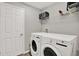 Functional laundry room with modern washer and dryer, shelving, and neutral wall color at 13111 Fruitville Way, Riverview, FL 33579