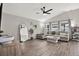 Bright living room showcasing vaulted ceiling, wood-look flooring, modern furnishings, and ample natural light at 13111 Fruitville Way, Riverview, FL 33579