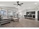 Open-concept living area with modern furnishings, lots of natural light, and an adjacent kitchen at 13111 Fruitville Way, Riverview, FL 33579