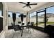 Inviting screened porch featuring a ceiling fan, dining set, and backyard view at 13111 Fruitville Way, Riverview, FL 33579
