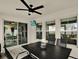 Inviting screened porch featuring a ceiling fan, dining set, and view of the backyard at 13111 Fruitville Way, Riverview, FL 33579
