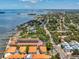 An aerial view showcasing waterfront condos close to the beach, a fishing pier, and near the city at 1340 Bayshore Blvd # 502, Dunedin, FL 34698