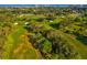 Breathtaking aerial shot of a golf course with lush green fairways, trees, and a glimpse of the sea at 1340 Bayshore Blvd # 502, Dunedin, FL 34698