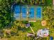 Overhead view of multiple tennis courts and a playground surrounded by lush trees, perfect for recreational activities at 1340 Bayshore Blvd # 502, Dunedin, FL 34698
