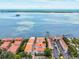 An aerial view showcasing waterfront condos with community boat docks and stunning views of the serene bay at 1340 Bayshore Blvd # 502, Dunedin, FL 34698