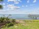 Lush backyard landscaping leads to the waterfront with a private wooden boat dock at 1340 Bayshore Blvd # 502, Dunedin, FL 34698