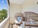 Cozy balcony featuring egg chairs with a beautiful view of the surrounding greenery at 1340 Bayshore Blvd # 502, Dunedin, FL 34698