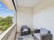 Relaxing outdoor balcony with chairs and a table, overlooking lush greenery at 1340 Bayshore Blvd # 502, Dunedin, FL 34698