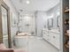 Luxurious bathroom featuring a soaking tub, glass shower, and double vanity at 1340 Bayshore Blvd # 502, Dunedin, FL 34698