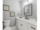 Stylish half bathroom featuring modern fixtures, white cabinetry and beautiful decorations at 1340 Bayshore Blvd # 502, Dunedin, FL 34698
