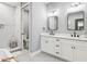 Modern bathroom with double vanity, sleek mirrors, and a glass-enclosed shower at 1340 Bayshore Blvd # 502, Dunedin, FL 34698