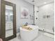 Modern bathroom featuring a standalone tub, a glass-enclosed shower, and neutral gray paint at 1340 Bayshore Blvd # 502, Dunedin, FL 34698