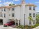Exterior view of a multi-story home with manicured landscaping and a red SUV at 1340 Bayshore Blvd # 502, Dunedin, FL 34698