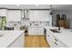 Bright kitchen featuring white cabinets, stainless steel appliances, and hardwood floors at 1340 Bayshore Blvd # 502, Dunedin, FL 34698