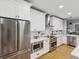 Stylish kitchen featuring stainless appliances, white cabinets, and modern fixtures at 1340 Bayshore Blvd # 502, Dunedin, FL 34698