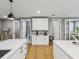 Open-concept kitchen featuring white cabinets, stainless appliances, and access to other rooms at 1340 Bayshore Blvd # 502, Dunedin, FL 34698