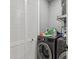 Efficient laundry room with front-loading washer/dryer and ample storage behind white louvered doors at 1340 Bayshore Blvd # 502, Dunedin, FL 34698