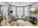 Comfortable living room featuring a cozy sofa, ottoman, bay windows with shutters, and modern decor at 1340 Bayshore Blvd # 502, Dunedin, FL 34698