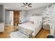 Well-lit main bedroom with a decorative bed, wood floors, and a sliding barn door at 1340 Bayshore Blvd # 502, Dunedin, FL 34698