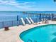 Gorgeous community pool area with lounge chairs and amazing views of the waterfront at 1340 Bayshore Blvd # 502, Dunedin, FL 34698