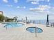 Gorgeous community pool and hot tub with tables and chairs overlooking the bay at 1340 Bayshore Blvd # 502, Dunedin, FL 34698