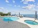 Beautiful community pool and hot tub with tables and chairs overlooking the bay at 1340 Bayshore Blvd # 502, Dunedin, FL 34698