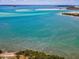 Expansive waterfront view featuring turquoise water, sandbars, and lush vegetation on a sunny day at 1340 Bayshore Blvd # 502, Dunedin, FL 34698