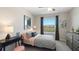 Bedroom featuring a large window, neutral tones, and stylish decor at 135 Mangrove Shade Cir, Apollo Beach, FL 33572