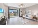 Modern living room featuring tile flooring, a cozy sofa, stylish decor, and large sliding glass doors to the outdoors at 135 Mangrove Shade Cir, Apollo Beach, FL 33572