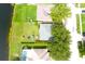 Aerial shot of a backyard with lush lawn, playset, and proximity to a serene lake at 1423 Birchstone Ave, Brandon, FL 33511