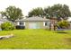 Spacious backyard with lush green grass, patio, and play equipment at 1423 Birchstone Ave, Brandon, FL 33511