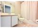 Cozy bathroom featuring a vanity, toilet, and shower with patterned curtain at 1423 Birchstone Ave, Brandon, FL 33511