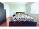 Bedroom with wood floor, a closet, and a large bed between two nightstands at 1423 Birchstone Ave, Brandon, FL 33511