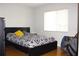 Bedroom with wood floor, a window, and a large bed between two nightstands at 1423 Birchstone Ave, Brandon, FL 33511
