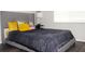 Bedroom with light walls, wood floor, and a queen bed with upholstered headboard at 1423 Birchstone Ave, Brandon, FL 33511