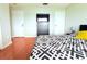 Bedroom with wood floor, a chest of drawers with mounted TV, and a large bed at 1423 Birchstone Ave, Brandon, FL 33511