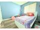 Cozy bedroom with blue walls, white furniture and luxury vinyl floors at 1423 Birchstone Ave, Brandon, FL 33511