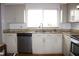 Kitchen features stainless dishwasher, granite countertops and bright cabinets at 1423 Birchstone Ave, Brandon, FL 33511