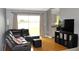 Bright living room with view of lake, gray leather sectional and open view to the kitchen at 1423 Birchstone Ave, Brandon, FL 33511