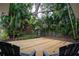 Relaxing backyard deck surrounded by lush tropical landscaping at 1506 Winding W Way, Clearwater, FL 33764