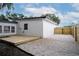 Side view of backyard with deck and gravel yard at 1506 Winding W Way, Clearwater, FL 33764