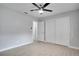 Bright bedroom with luxury vinyl plank flooring, a ceiling fan, a walk-in closet, and an en suite bathroom at 1506 Winding W Way, Clearwater, FL 33764