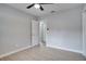 Neutral bedroom with luxury vinyl plank flooring, a ceiling fan, and walk in closet with en suite bathroom at 1506 Winding W Way, Clearwater, FL 33764