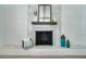 This charming fireplace features a modern white brick surround, a sleek black mantle, and tiled hearth for a cozy at 1506 Winding W Way, Clearwater, FL 33764